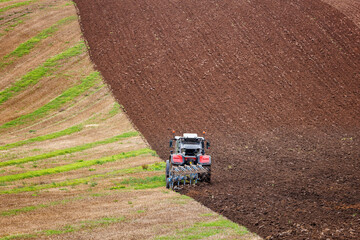 Tractor Ploughing Field on a slight incline