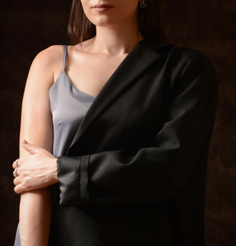 Beautiful young girl in black clothes. portrait of young model. Portrait of young woman with dark hair in black dress with brown background. Sexy lady. Fashion time