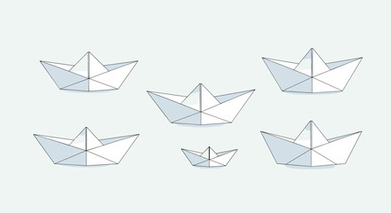 Origami paper boats floating on a calm pale blue water surface representing teamwork and navigation