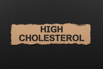 Torn cardboard showing a high cholesterol warning on a dark backdrop. Symbolic illustration of elevated cholesterol levels. Space for text included.