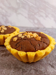 Pie brownies or pie with brownie filling and almond topping. Selective focus in grey background.
