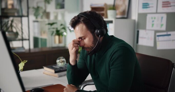 Businessman, headset and callcenter with headache at office, burnout or difficult customer support call. Help desk, computer and tired agent with challenge and problem solving fail with migraine