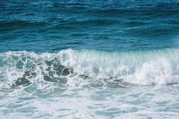Fototapeta premium Ocean waves crashing on volcanic shores