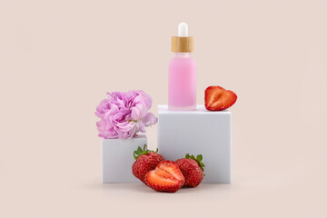 A dropper bottle on a white podium, a rose flower and strawberries on a beige background....