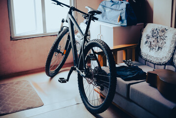 A retro styled photo of a bicycle in a small living room