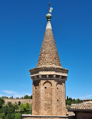 tower of the ducal palace in Urbino against a blue sky