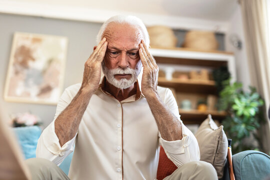 Stress, headache and senior man in home with worrying, overthinking or mental health. Anxiety, mistake and elderly male person with migraine in living room for regret, vertigo or brain fog in house. - Powered by Adobe