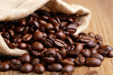 Fototapeta premium High Resolution Coffee Beans Spilling from Burlap Sack