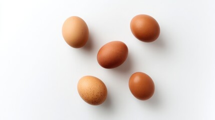 Brown eggs neatly arranged on a white surface, showcasing simplicity and natural food.