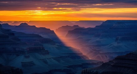 The Grand Canyon at sunset with dramatic light rays piercing through the layered rock formations, creating a stunning vista.
