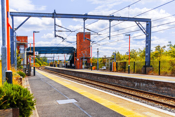 Fototapeta premium Electrified suburban passenger rural commuter railway line England UK