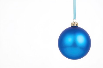 Glass ball Christmas ornament hanging on ribbon, close-up isolated on white background, festive winter decoration for holiday celebrations