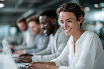 Smiling caucasian woman working on laptop with multiethnic team in modern office