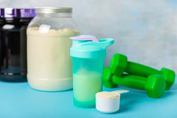 Protein powder. protein shake. Shaker bottle with protein. Food supplement. Whey protein powder with shaker for mixing. Sports nutrition. Concept of sports and healthy lifestyle. Sports equipment