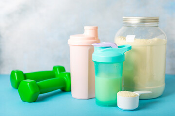 Protein powder. protein shake. Shaker bottle with protein. Food supplement. Whey protein powder with shaker for mixing. Sports nutrition. Concept of sports and healthy lifestyle. Sports equipment