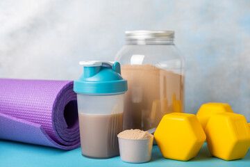 Protein powder. protein shake. Shaker bottle with protein. Food supplement. Whey protein powder with shaker for mixing. Sports nutrition. Concept of sports and healthy lifestyle. Sports equipment