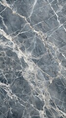 Fototapeta premium A refined close-up of polished dark gray marble, showcasing elegant white and light gray veining with smooth tonal depth. The luxurious stone texture is highlighted with soft, even lighting, making it