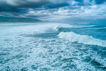 A dramatic and stormy sea with massive crashing waves