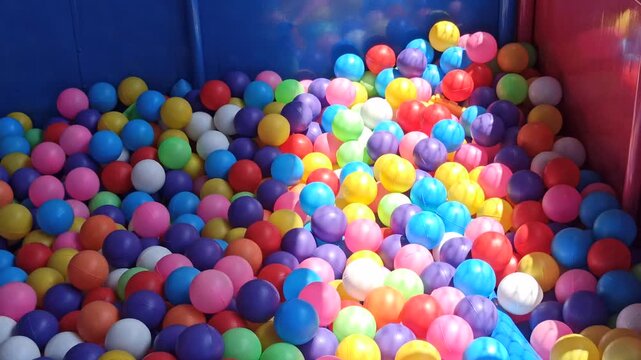 A colorful ball pit filled with vibrant plastic balls, creating a playful and cheerful atmosphere for children&rsquo;s fun and recreation.