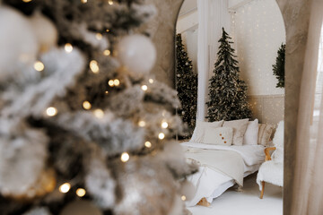 A cozy bedroom is beautifully decorated for the holidays, showcasing a vibrant Christmas tree...