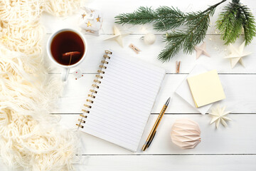 Notepad, pen, cup of tea for writing plan or Christmas wish list. Next year goals, mock up