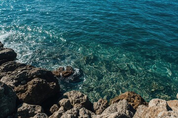 Rocky shoreline with ocean waves and clear water