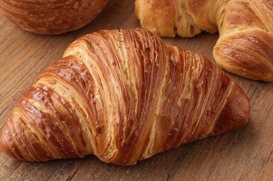 Freshly baked croissant close-up, perfect for breakfast and homemade bakery delights