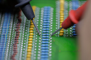 Macro Shot of Multimeter Probes on Circuit Board Components