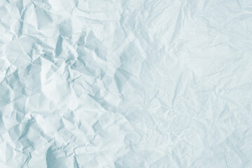 Crumpled white paper background.