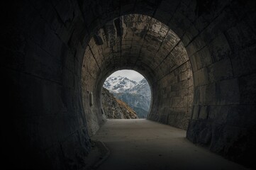 Fototapeta premium Dark passageway inside alpine mountain range