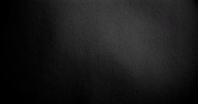 The large, grainy, dark texture of real cinema. Surface of black paper, slowly rotating. Use for background and texture.	