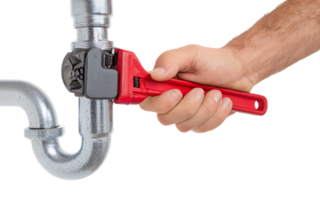 Hand using an adjustable wrench on a pipe.