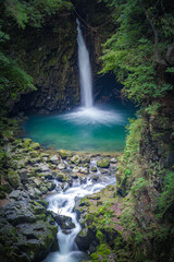 Obraz premium Hidden (secret) Waterfall in the volcanic terrain with columnar joint and river cave (corrasional cave), Hantan River, Dove's Pocket (nest) Waterfall, South Korea