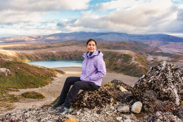 Beautiful asian woman enjoying with Tama Lakes viewpoint and Mount Ruapehu hiding in the cloud on...