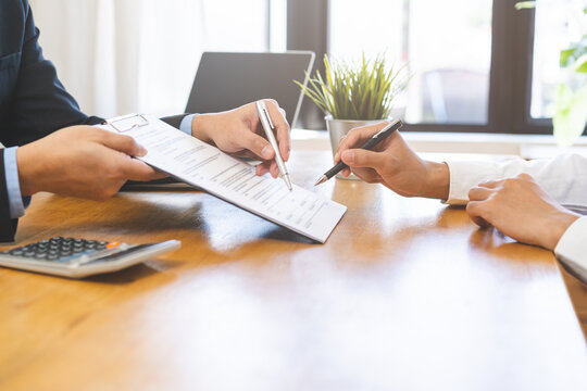 Asian landlord, realtor man pointing on paper for sign signature contract with tenant rental or client, realtor purchase, buyer home or apartment, agreement mortgage, property lease agent concept.