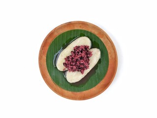 Tape uli or Indonesian traditional food made from fermented black glutinous rice on wooden plate...