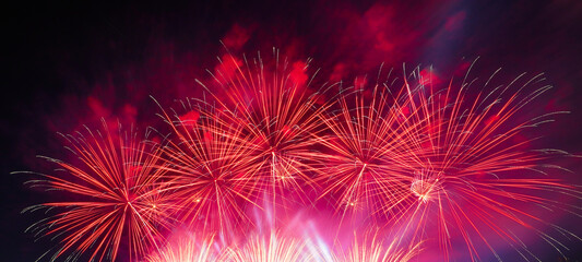 Nighttime fireworks or sparklers symbolize a festive celebration.
