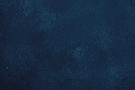 Dark navy blue textured paint wall with grainy abstract design
