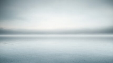 Fototapeta premium A serene landscape featuring calm waters and a soft, misty horizon, creating a tranquil and minimalist atmosphere.