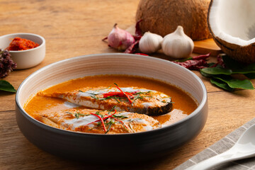 Siriped catfish with dried red curry sauce.Thai curry paste (Chu Chee) stir-fried with coconut milk and catfish in white plate.