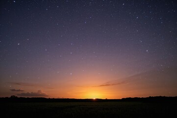 Stunning dawn beneath a starry galaxy nightscape