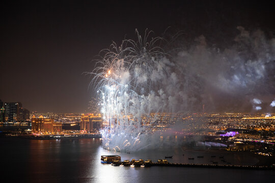 Aerial view of Qatar National Day fireworks lighting up the night sky over Doha, celebrating the nation&rsquo;s heritage and unity &ndash; stock footage.