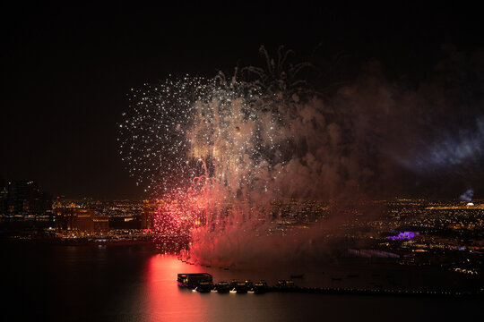 Aerial view of Qatar National Day fireworks lighting up the night sky over Doha, celebrating the nation&rsquo;s heritage and unity &ndash; stock footage.