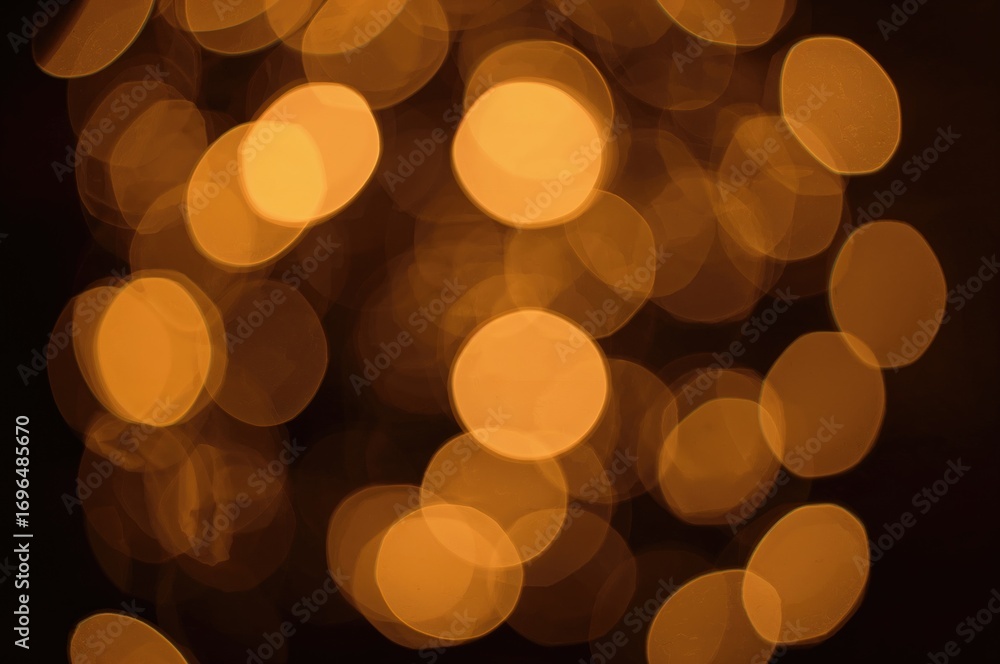 Poster soft glowing orbs create a warm golden bokeh effect on a dark backdrop, perfect for overlays and bac
