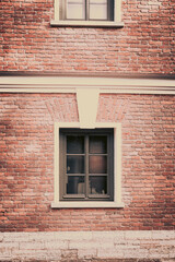 An antique window on a brick wall
