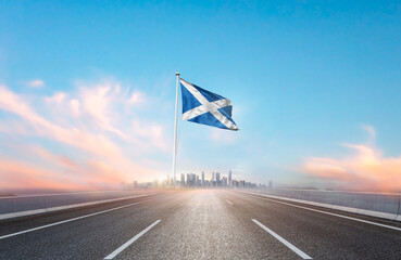 Scotland national flag with mast waving with beautiful skyline. A view from highway. Scotland flag...