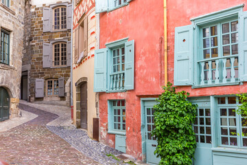 Colorful houses at a cobblestoned street in Le Puy-en-Velay, France