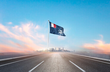 French Southern and Antarctic Lands national flag with mast waving with beautiful skyline. A view...