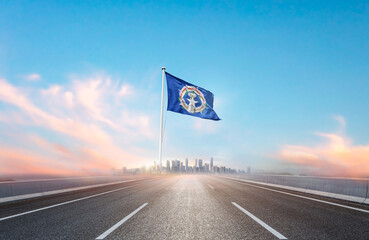 Northern Mariana Islands national flag with mast waving with beautiful skyline. A view from...