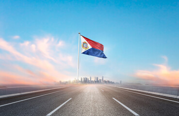 Sint Maarten national flag with mast waving with beautiful skyline. A view from highway. Sint...